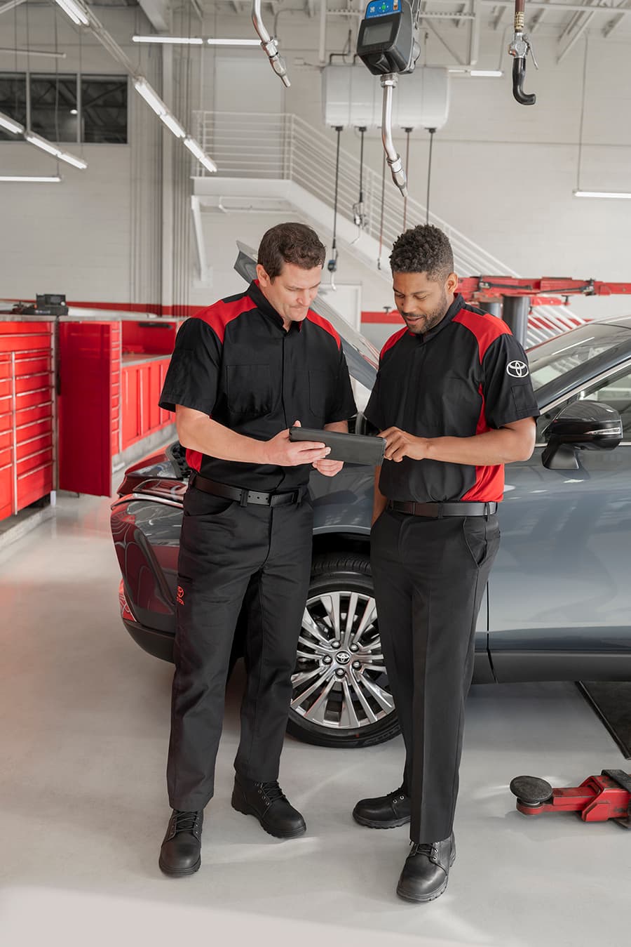 Toyota Technician Showing Off Available Amenities At A Valley Toyota Dealer Service Center